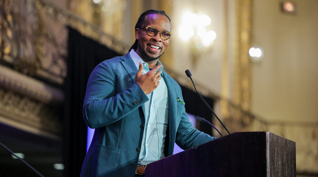 Photo if Dr. Ibram X. Kendi speaking at a podium at the Rally for the Right to Read.