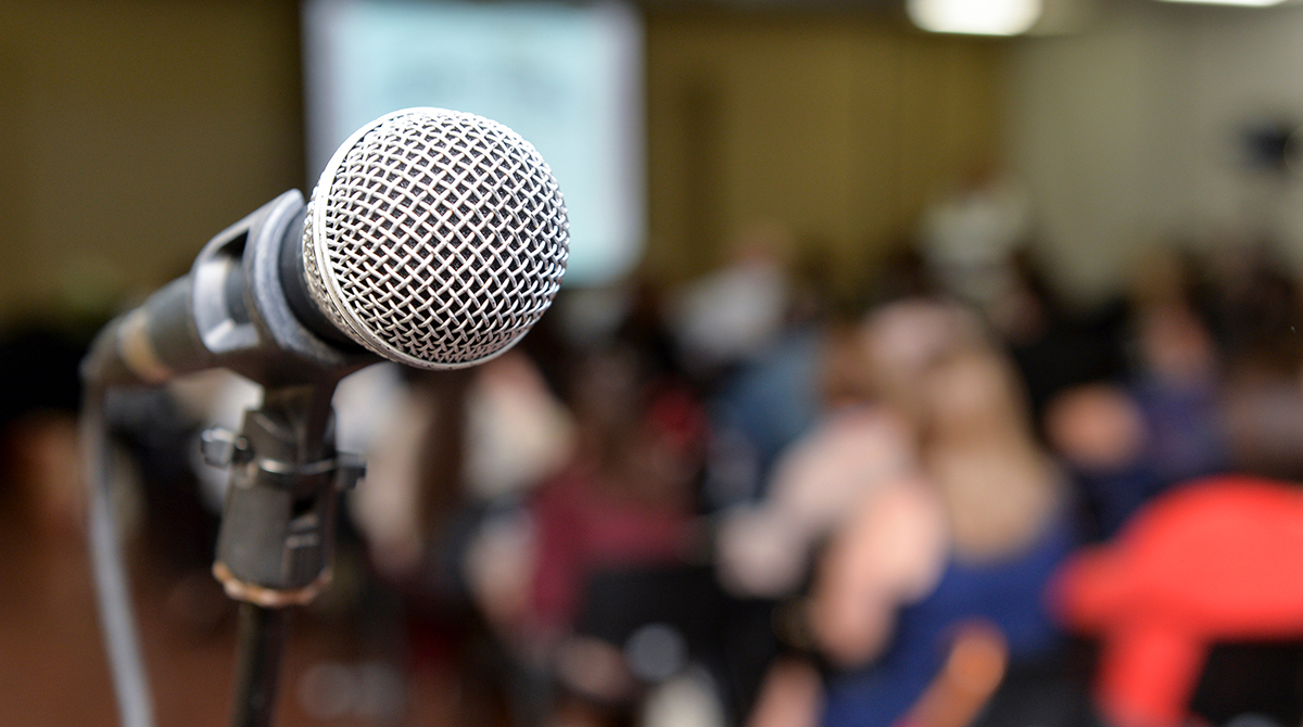 Close-up photo of a microphone at a meeting