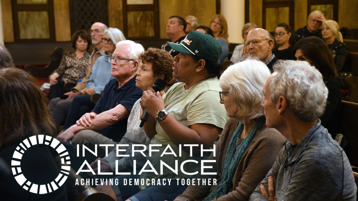 People in a church having an engaging conversation. Interfaith Alliance: Achieving Democracy Together