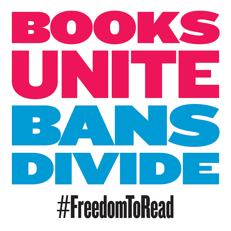 White placard that reads "BOOKS UNITE BANS DIVIDE #FreedomToRead"