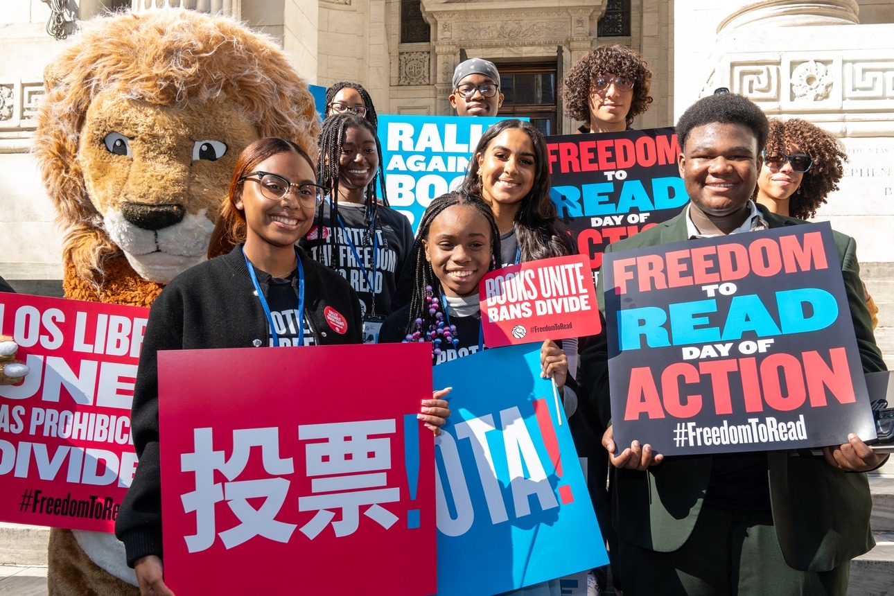 Teen Reading Ambassadors from The New York Public Library participating in the 10/19 Freedom to Read Day of Action and holding signs.